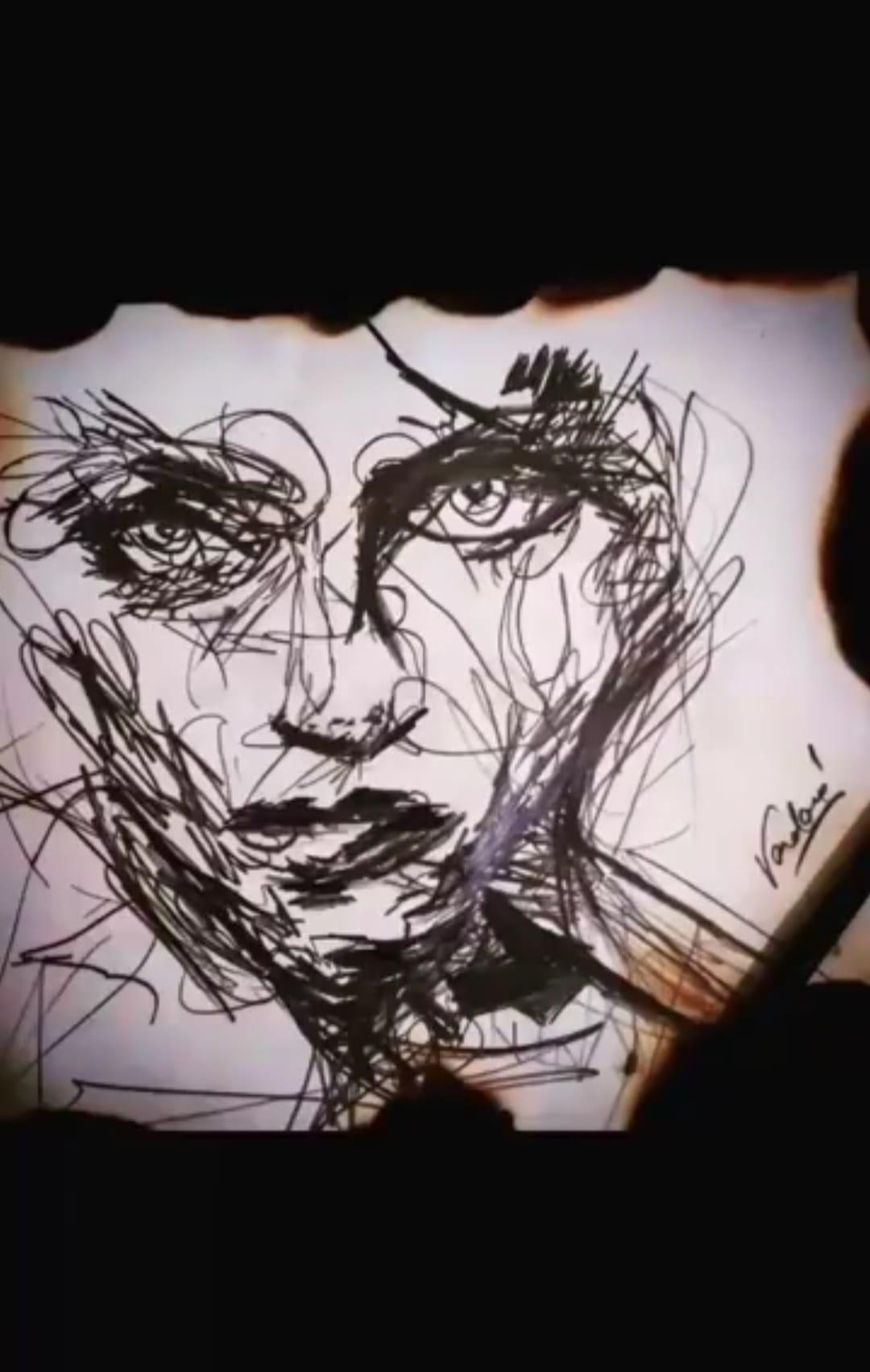 Fire and Ice — expressive ink sketch on burnt paper by Vandana Tiwari, 2022. A fragmented face drawn in restless abstract lines, the edges of the paper scorched and burned.